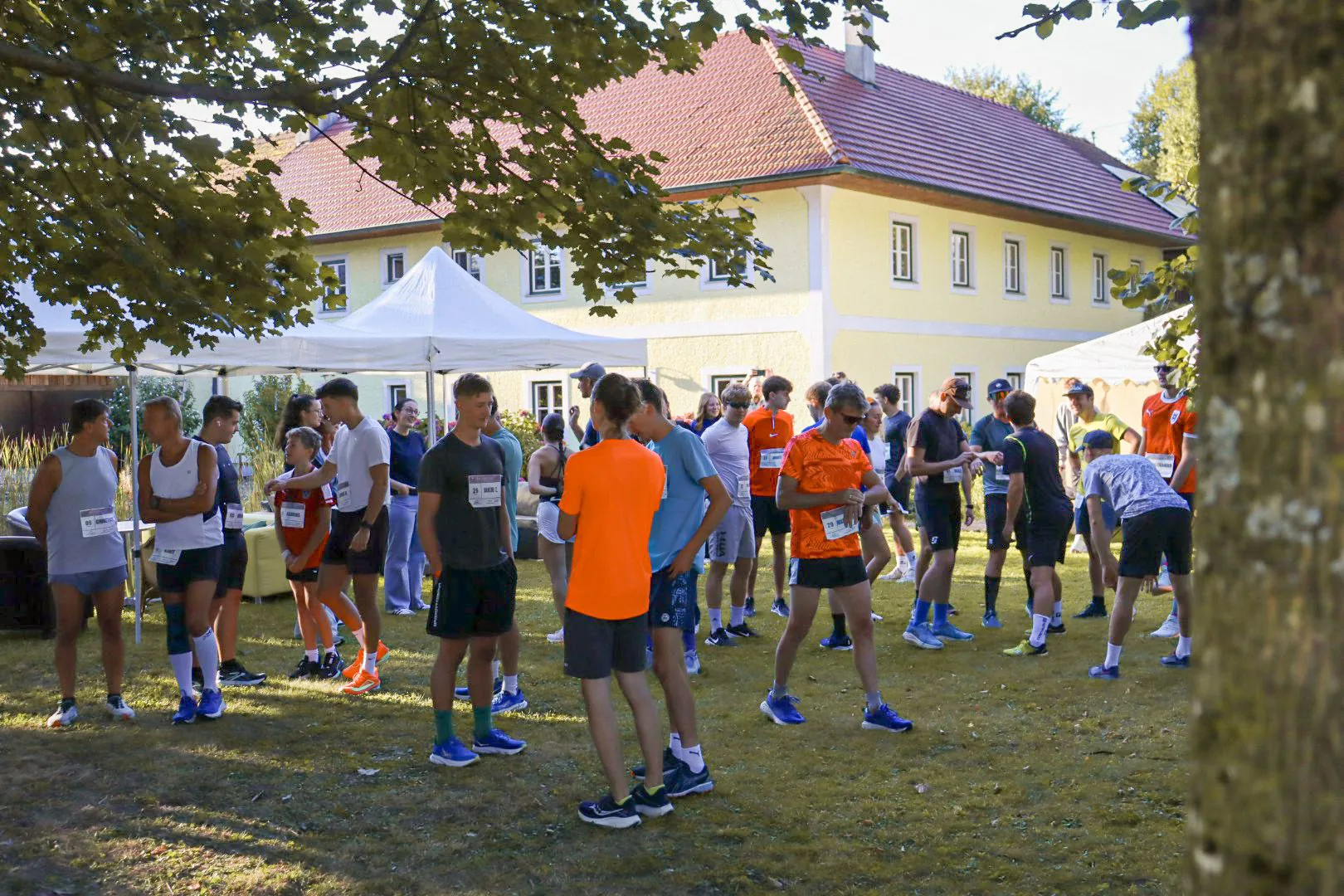 Läufer:innen versammeln sich vor dem Start am Hof, 2025